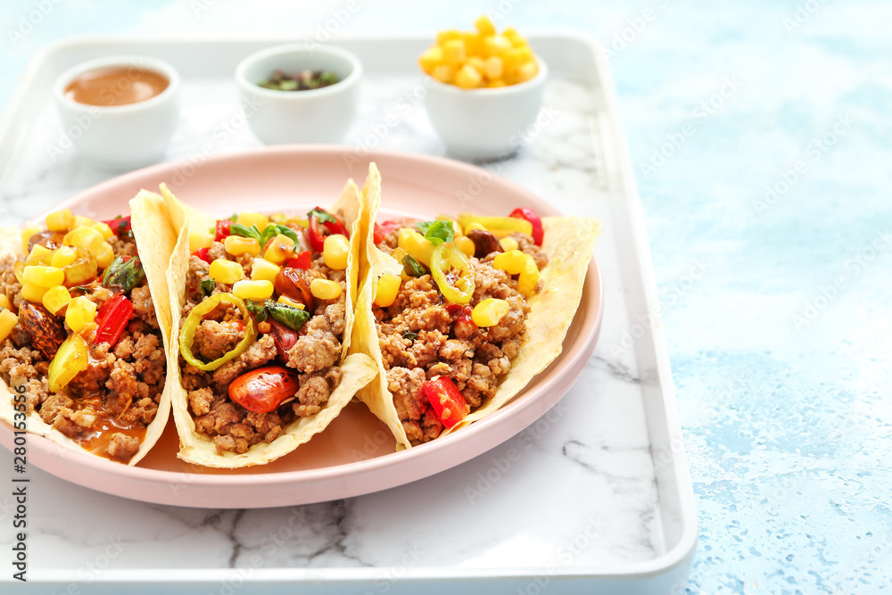 Plate with tasty fresh tacos on light color background Plate with tasty fresh tacos on light color background