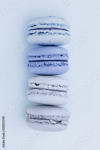 Fresh blue-colored macarons on a flat lay blue background. Shades of blue colors. French dessert.