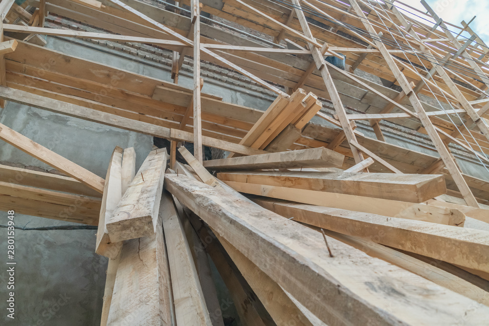 Home construction. Wooden scaffolding on a building close up Home construction. Wooden scaffolding on a building close up