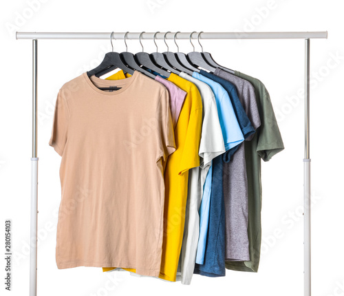 Rack with hanging clothes on white background