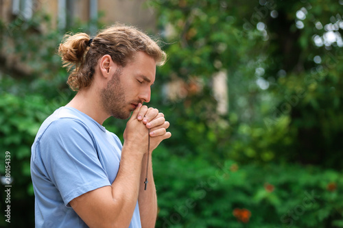 Religious young man praying...