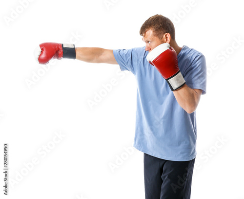 Strong male boxer on white ...