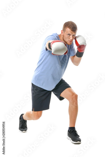 Strong male boxer on white ...