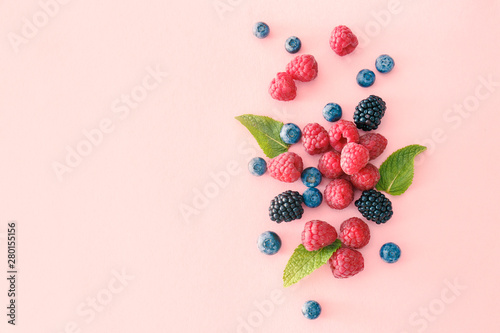 Sweet ripe berries on color background photo
