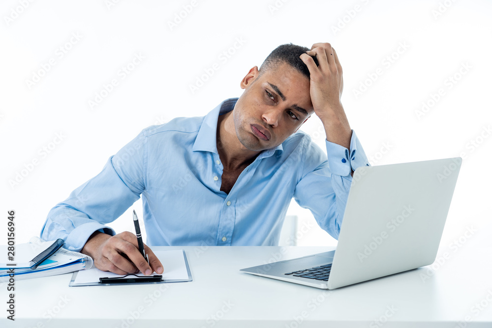 Desperate young businessman working on laptop going crazy with loads of work Desperate young businessman working on laptop going crazy with loads of work