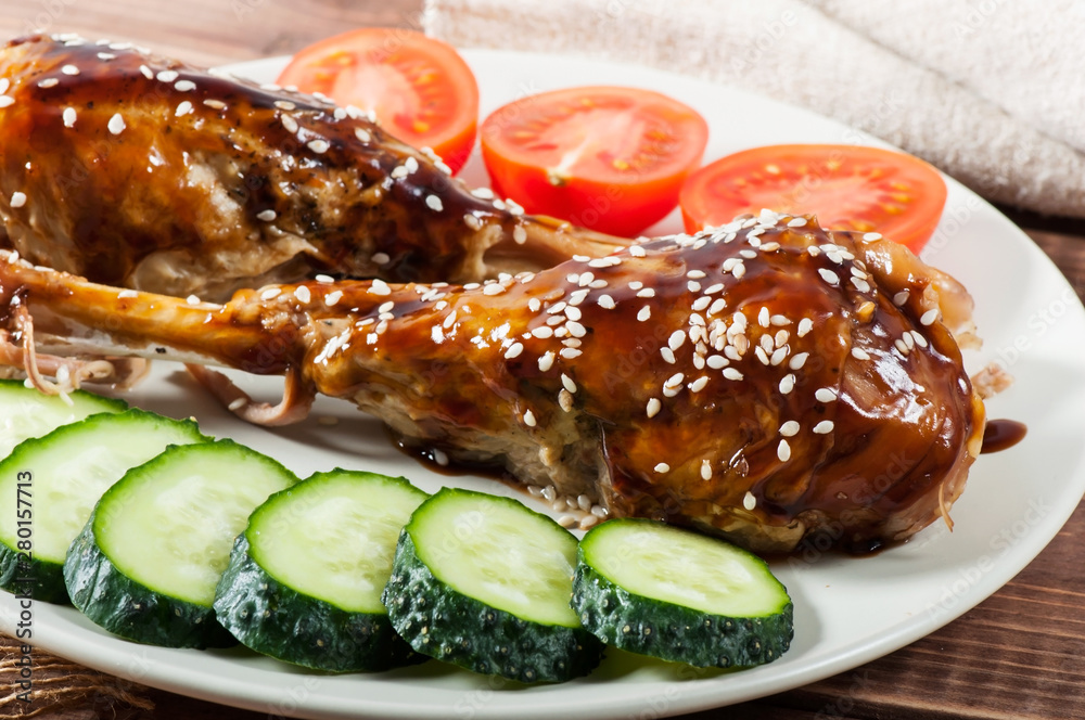 Grilled chicken with teriyaki sauce and vegetables on an old wooden background. Grilled chicken with teriyaki sauce and vegetables on an old wooden background.
