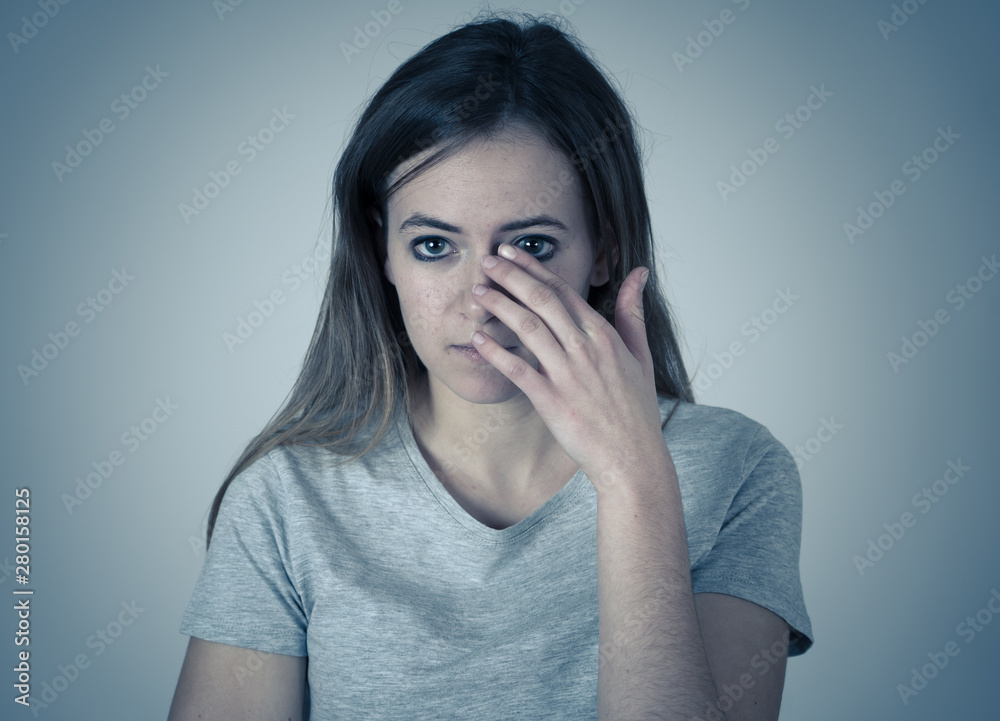 Young, sad, unhappy, helpless girl suffering from depression. Human emotions, bulling and portraits Young, sad, unhappy, helpless girl suffering from depression. Human emotions, bulling and portraits