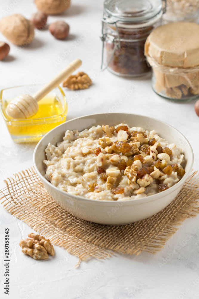 Oatmeal with nuts (hazelnuts, walnuts) and honey, porridge for Breakfast. Tasty, healthy food Oatmeal with nuts (hazelnuts, walnuts) and honey, porridge for Breakfast. Tasty, healthy food