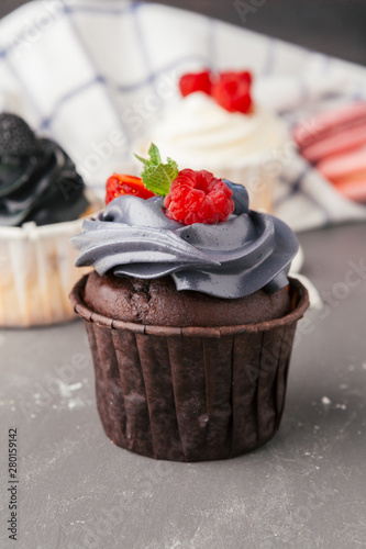 Delicious raspberry cupcakes on dark background - Handmade Sweet dessert