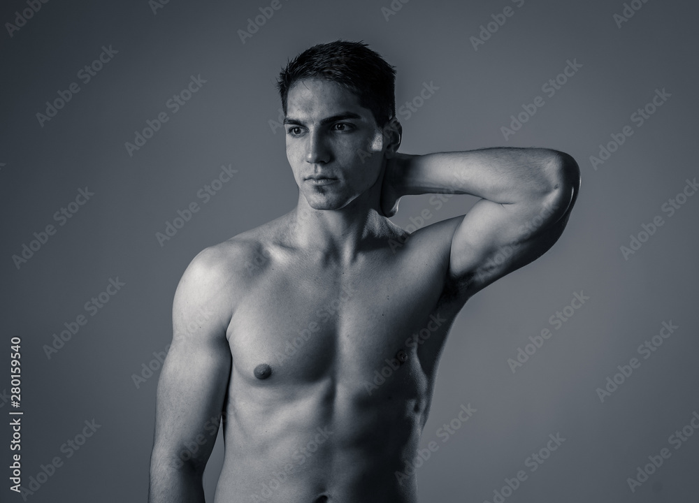 Half length portrait of strong healthy handsome Athletic man isolated on neutral background