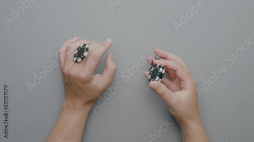 Playing with Poker Fiches over a Clean Destkop. Natural Grey Minimal Background. photo