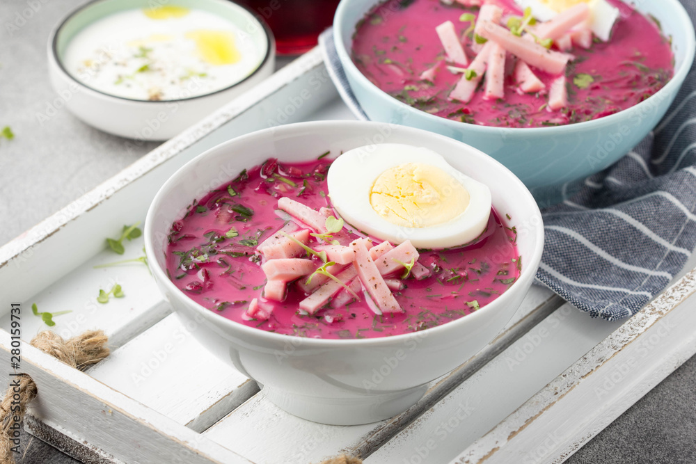 Cold beet soup, traditional Lithuanian dish, summer food. Fresh vegetables (cucumbers, radishes, green onions, cilantro), sour cream, egg, ham Cold beet soup, traditional Lithuanian dish, summer food. Fresh vegetables (cucumbers, radishes, green onions, cilantro), sour cream, egg, ham
