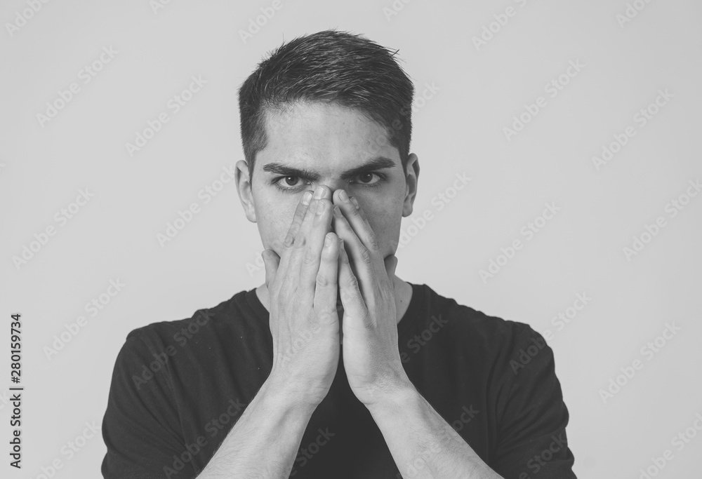 Portrait of sad and depressed young man feeling upset. Human expressions and negative emotions Portrait of sad and depressed young man feeling upset. Human expressions and negative emotions