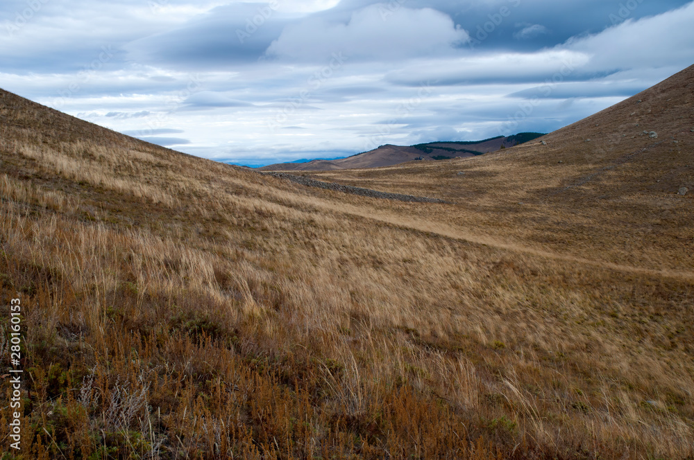 Barguzin Valley Russia, view of wind swept grasslands with stormy sky