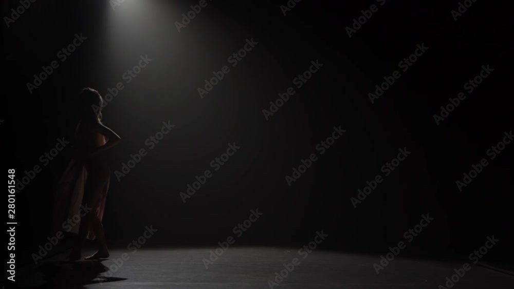 Motion of a girl practicing contemp in dark studio. Motion of a girl practicing contemp in dark studio.