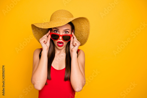Photo of amazing lady bright lipstick nice colorful look came seaside trip voyage staring cold water ocean oh no wear specs sun hat red swimming suit isolated yellow background