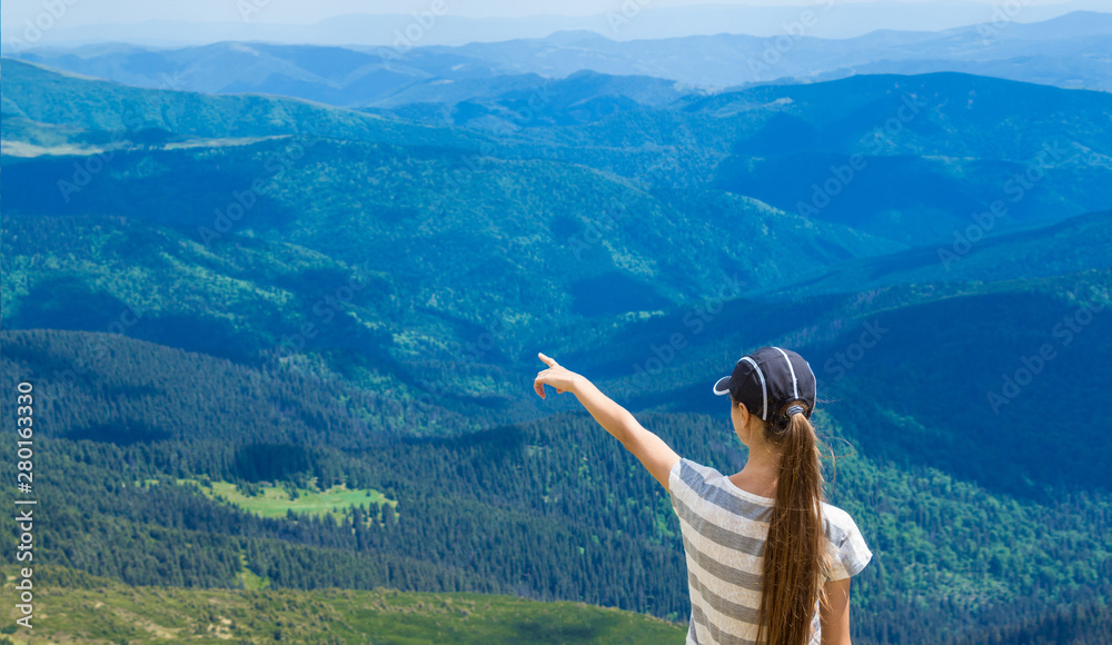 woman hiking pointing to the sky enjoy the beautiful view at mountain for sun light