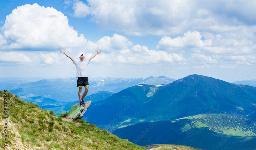 Man on top of a rocky mountain with beautiful view