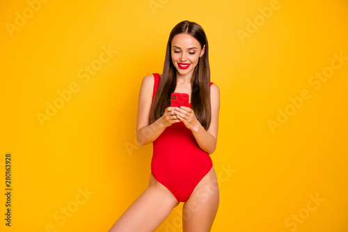 Portrait of her she nice-looking attractive glamorous lovely alluring charming cheerful cheery straight-haired lady browsing isolated over bright vivid shine yellow background