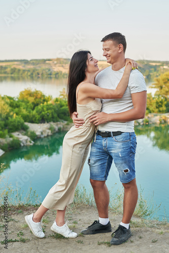 Family travel on vacation near lake in summer. Tourist enjoying on vacation. Relax on lake. Summer vacation. Camping, picnic near lake.Romantic date on background of landscape.Couple in love