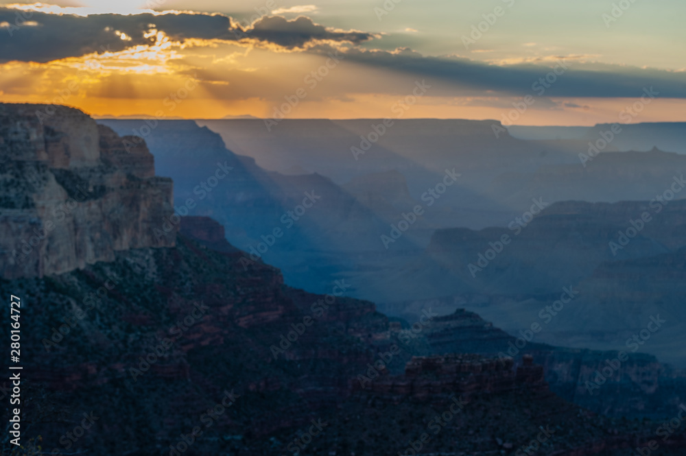 The setting sun sinking below the horizon of the Grand Canyon, near Yavapai point on the southern canyon rim.