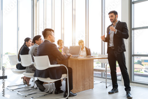 Businesspeople discussing together in conference room during meeting at office.