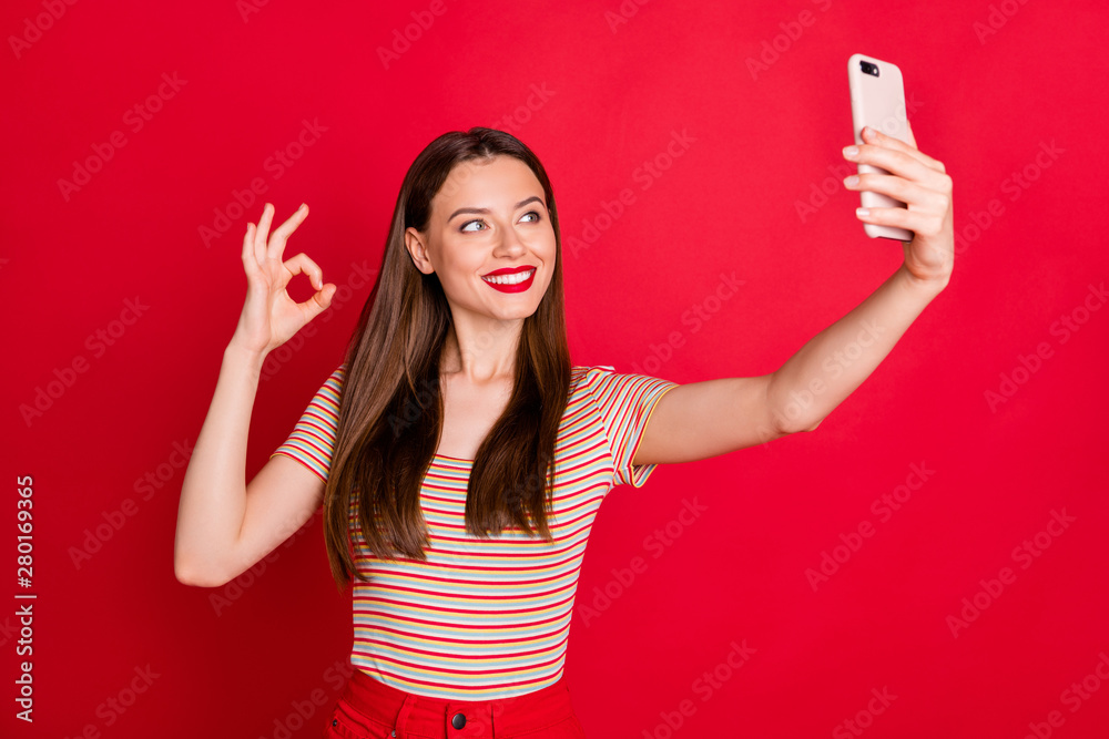 Photo of pretty dreamy cute nice glad charming lady making self portrait on digital modern device hold in hand isolated bright background Photo of pretty dreamy cute nice glad charming lady making self portrait on digital modern device hold in hand isolated bright background
