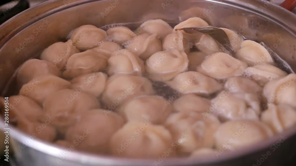 close-up of dumplings boiled in a saucepan wiping water cooking homemade food close-up of dumplings boiled in a saucepan wiping water cooking homemade food
