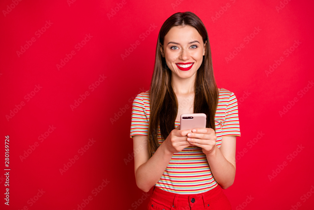 Photo of pretty charming funky lady in almost total red look holding checking-in her flight on smart phone isolated bright background Photo of pretty charming funky lady in almost total red look holding checking-in her flight on smart phone isolated bright background
