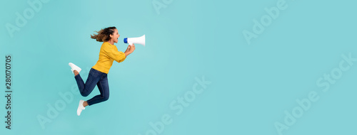 Obraz na plátně Girl with megaphone jumping and shouting