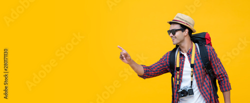 Young Asian tourist pointing to empty space