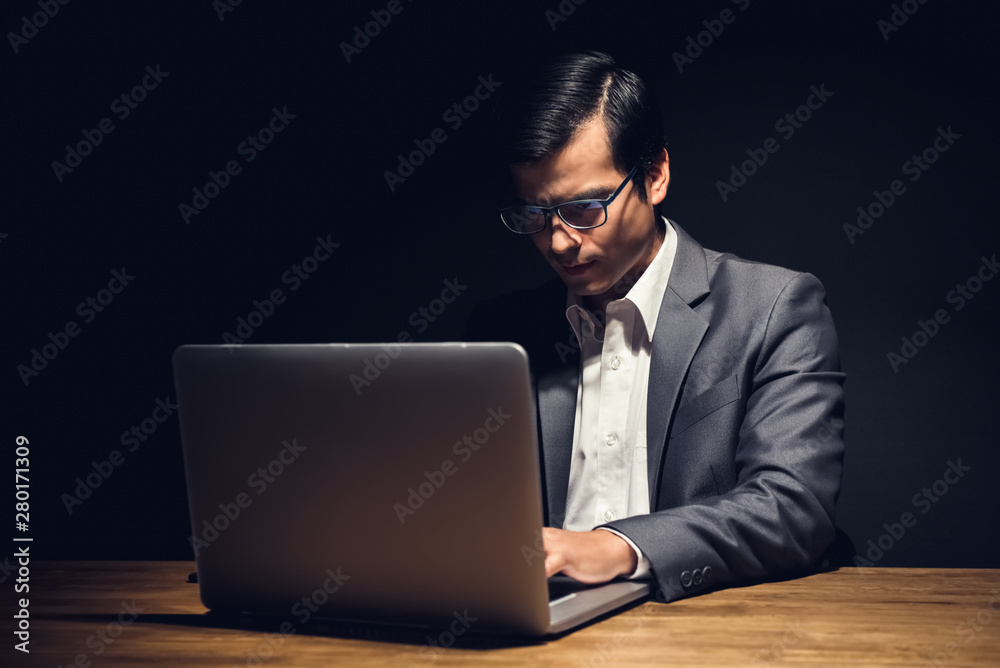 Busy businessman working in office late at night Busy businessman working in office late at night