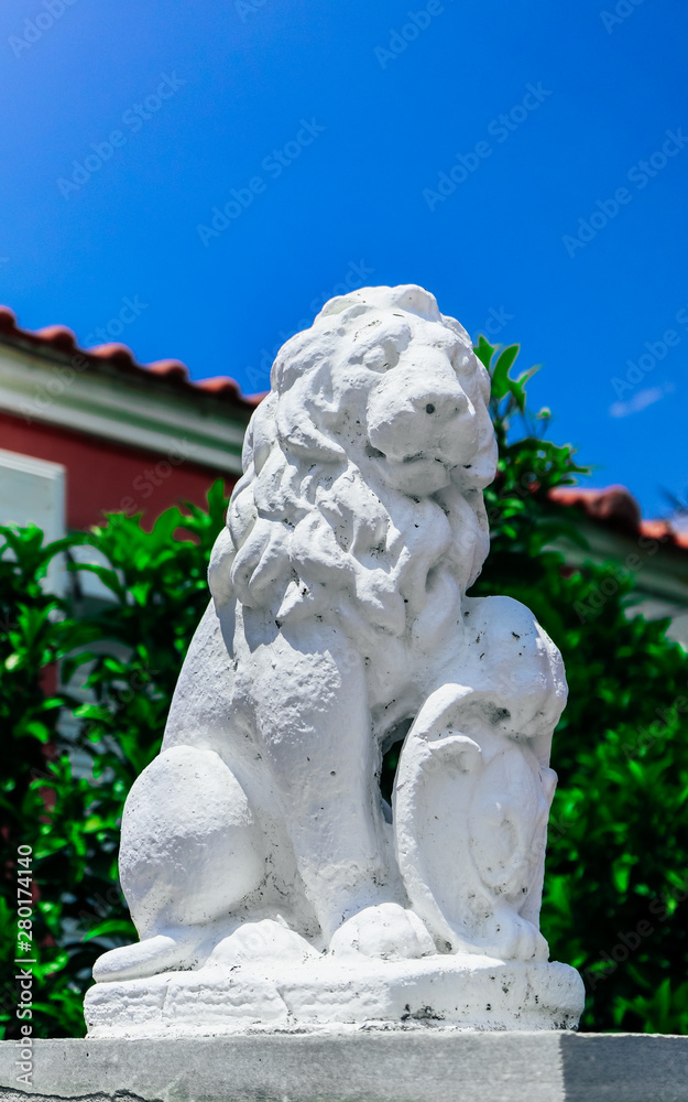 White lion guard, entrance gate sculpture, old Greek house statue decoration. Historical place excursion concept.