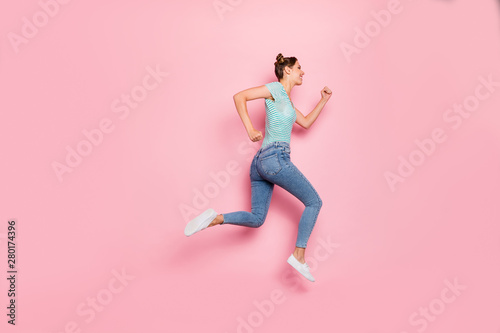 Full length body size profile side view of her she nice-looking lovely charming slender strong purposeful cheerful cheery girl hurrying isolated over pink pastel background