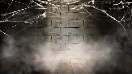 Halloween background. Background of old brick wall, cobweb, smoke, concrete floor