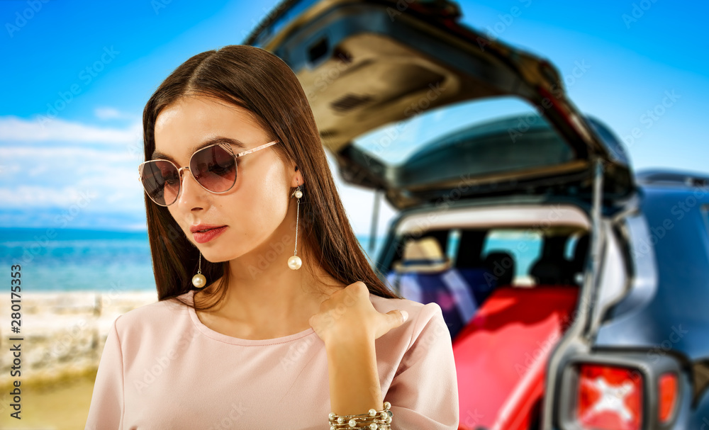 Summer background with a girl and black car in a beautiful sunny sandy beach and blue ocean view. Summer background with a girl and black car in a beautiful sunny sandy beach and blue ocean view.