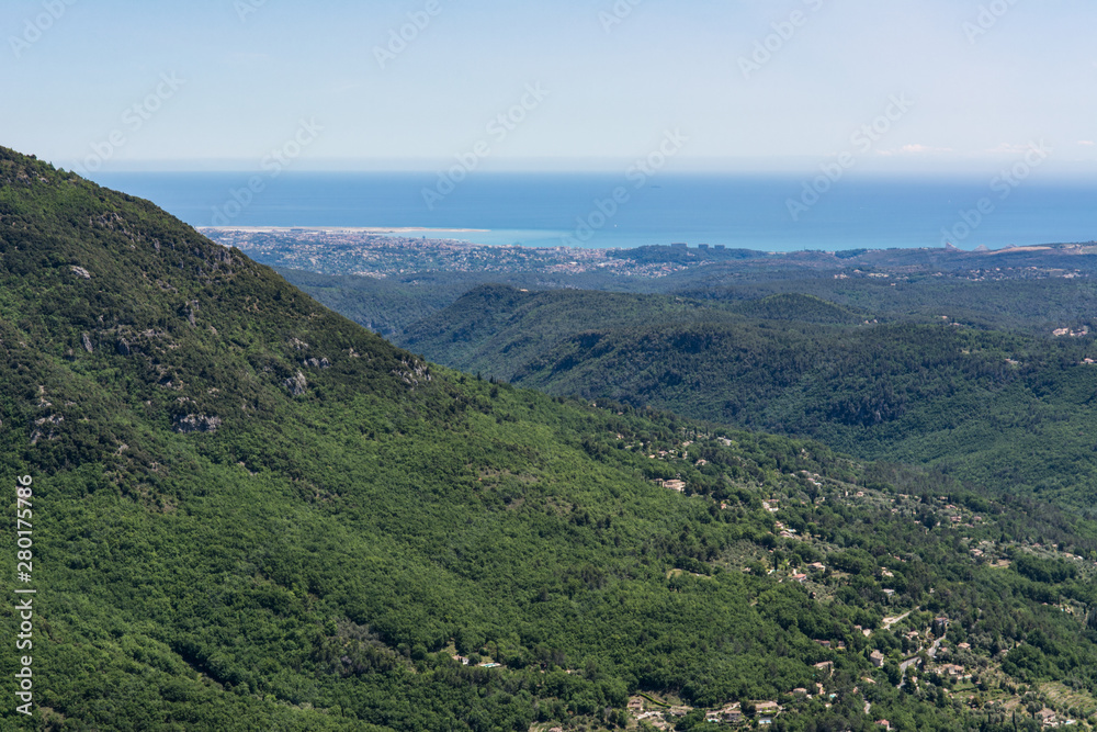 View of  Mediterranean Sea and surrounding mountains from village Gourdon in France.