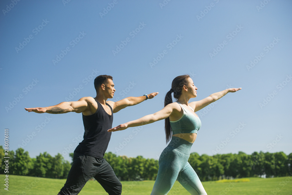 Man and woman practicing yoga outdoor Man and woman practicing yoga outdoor