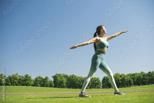 Athletic woman practicing yoga outdoor