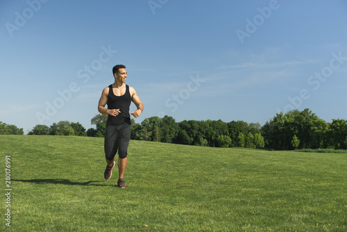Athletic man running outdoor in a park