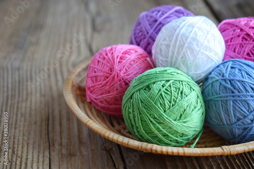 The equipment for knitting and crochet hook, colorful rainbow cotton yarn, ball of threads, wool. Handmade crocheting crafts. DIY concept. Copy space