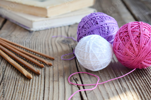The equipment for knitting and crochet hook, colorful rainbow cotton yarn, ball of threads, wool. Handmade crocheting crafts. DIY concept. Copy space photo