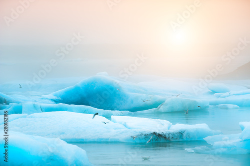 Canvas Print Blue icebergs in Jokulsarlon glacial lagoon at sunset, southern Iceland