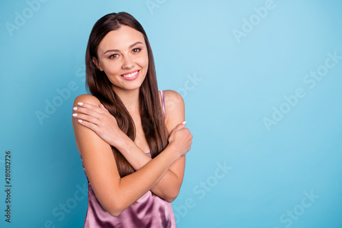 Portrait of her she nice-looking attractive lovely sweet cheerful cheery kind girl hugging herself enjoying cosy isolated over bright vivid shine teal blue green turquoise background