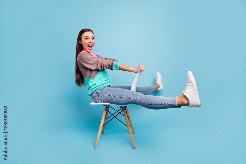 Full length photo of amazed rejoicing glad positive nice creative teen girl imaging she ridding a horse or bicycle isolated bright background Full length photo of amazed rejoicing glad positive nice creative teen girl imaging she ridding a horse or bicycle isolated bright background