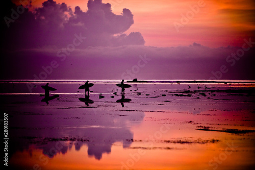 Photography Three surfers walking on the beach at sunset with surfboards in Weligama, Sri La