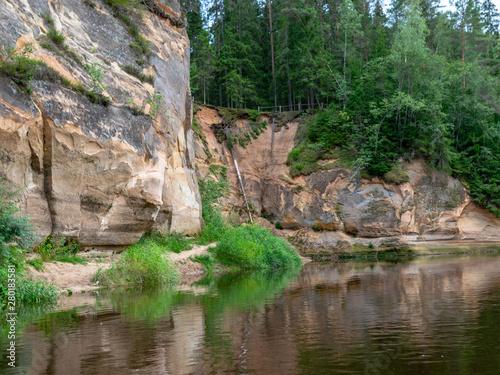 Sandstone cliffs in the evening light, cliff and tree reflections, Ergļu cliffs, Latvia