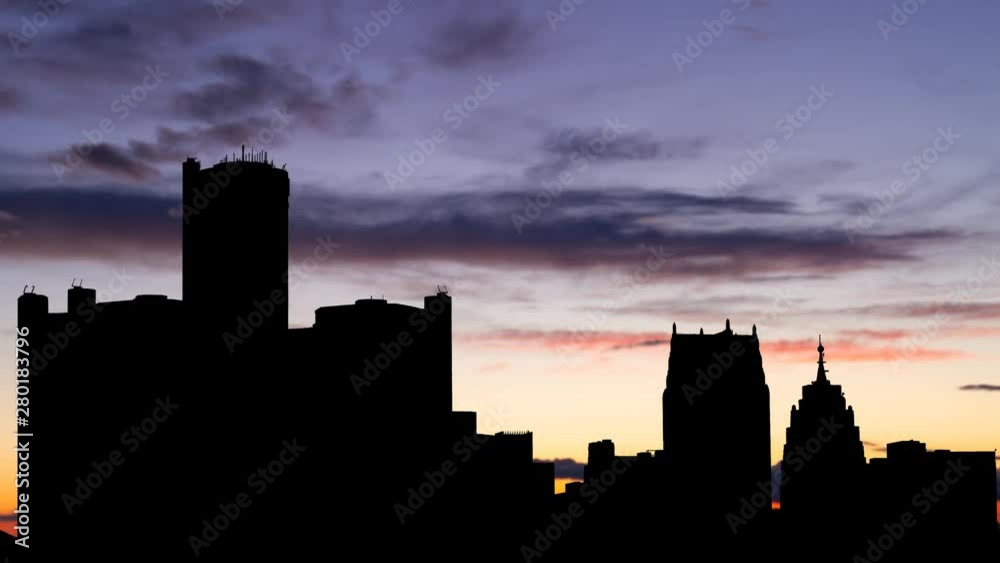 Detroit Skyline at Twilight, Time lapse with Colorful Sky, Clouds and Skyscrapers in Silhouette, Michigan, USA Detroit Skyline at Twilight, Time lapse with Colorful Sky, Clouds and Skyscrapers in Silhouette, Michigan, USA