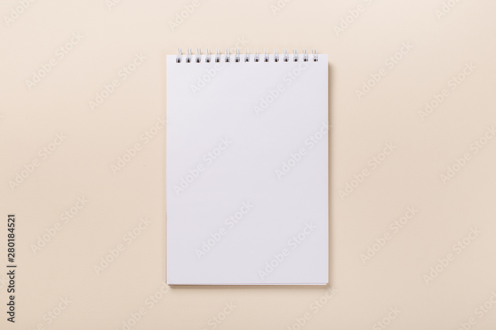 school notepad and pen on the beige desk. spiral notepad on a table. flatlay school notepad and pen on the beige desk. spiral notepad on a table. flatlay
