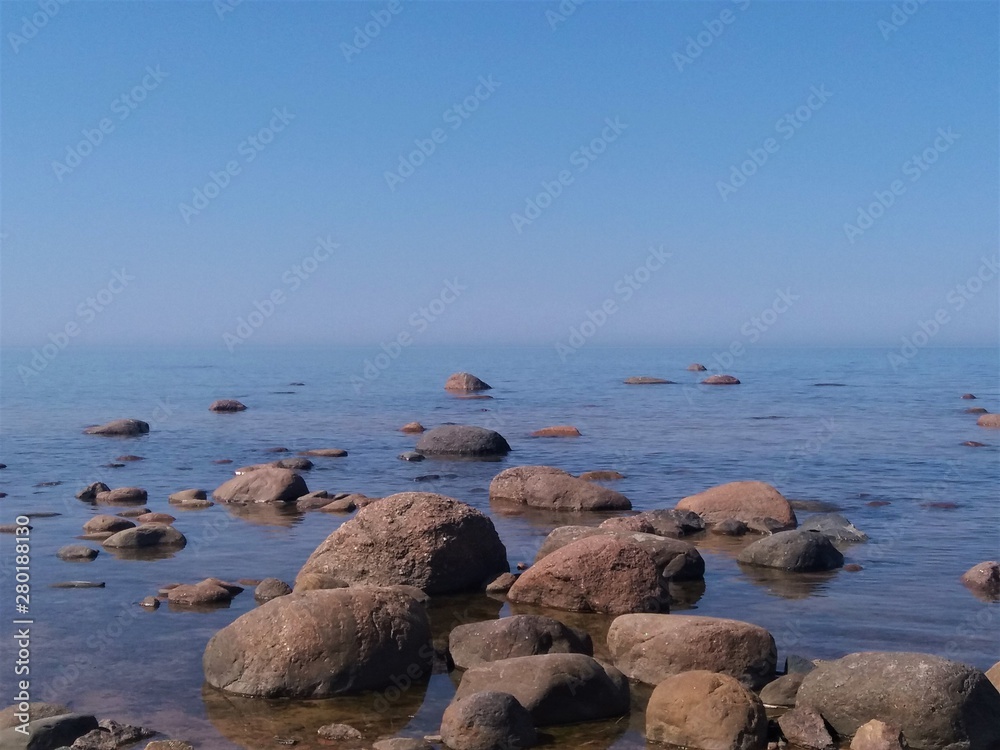 Gulf of Finland, cold northern Baltic Sea, Finland. The beauty of the northern summer. Sea, beach, large stones, horizon. Calm, peace, deserted. Introvert dream